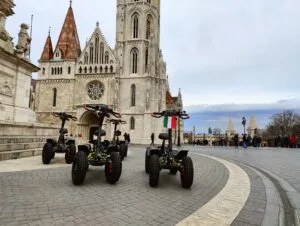 EZRaider vehicles are parked in front of Matthias Church in Budapest